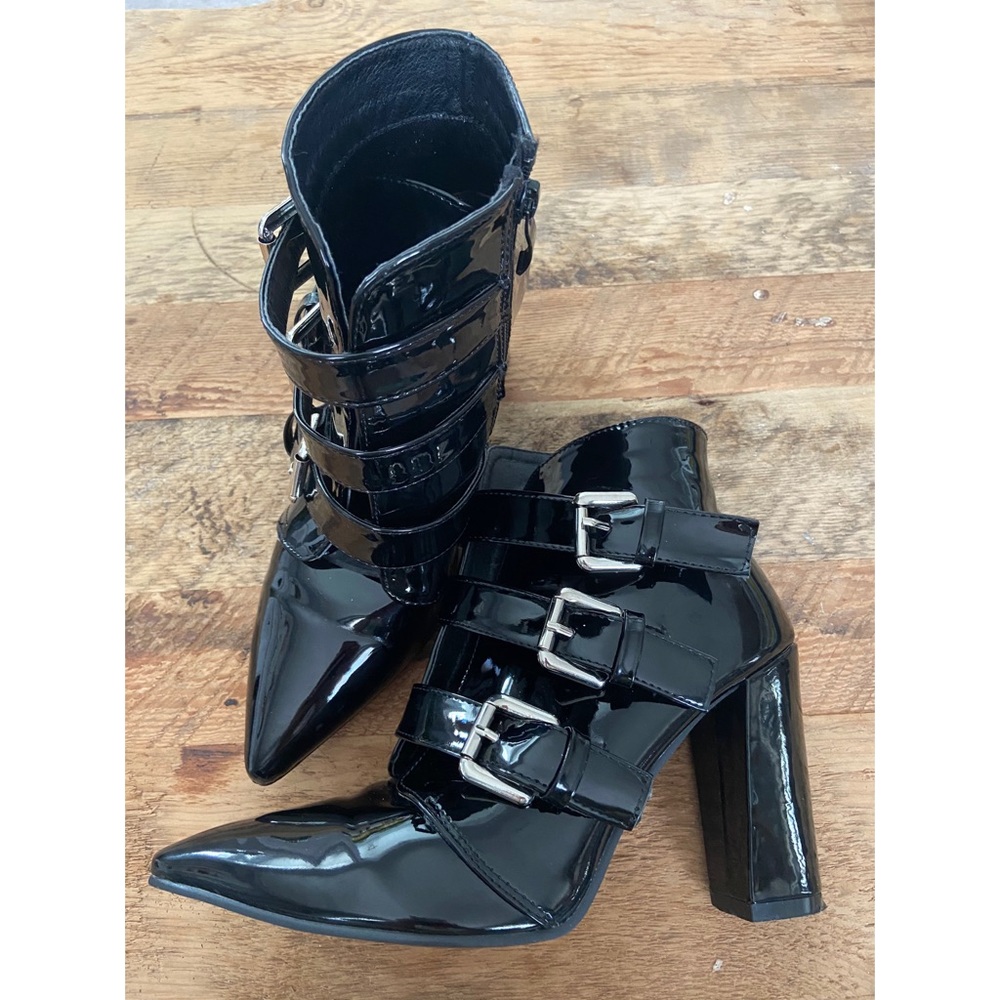 Patent leather heeled boots with silver buckles